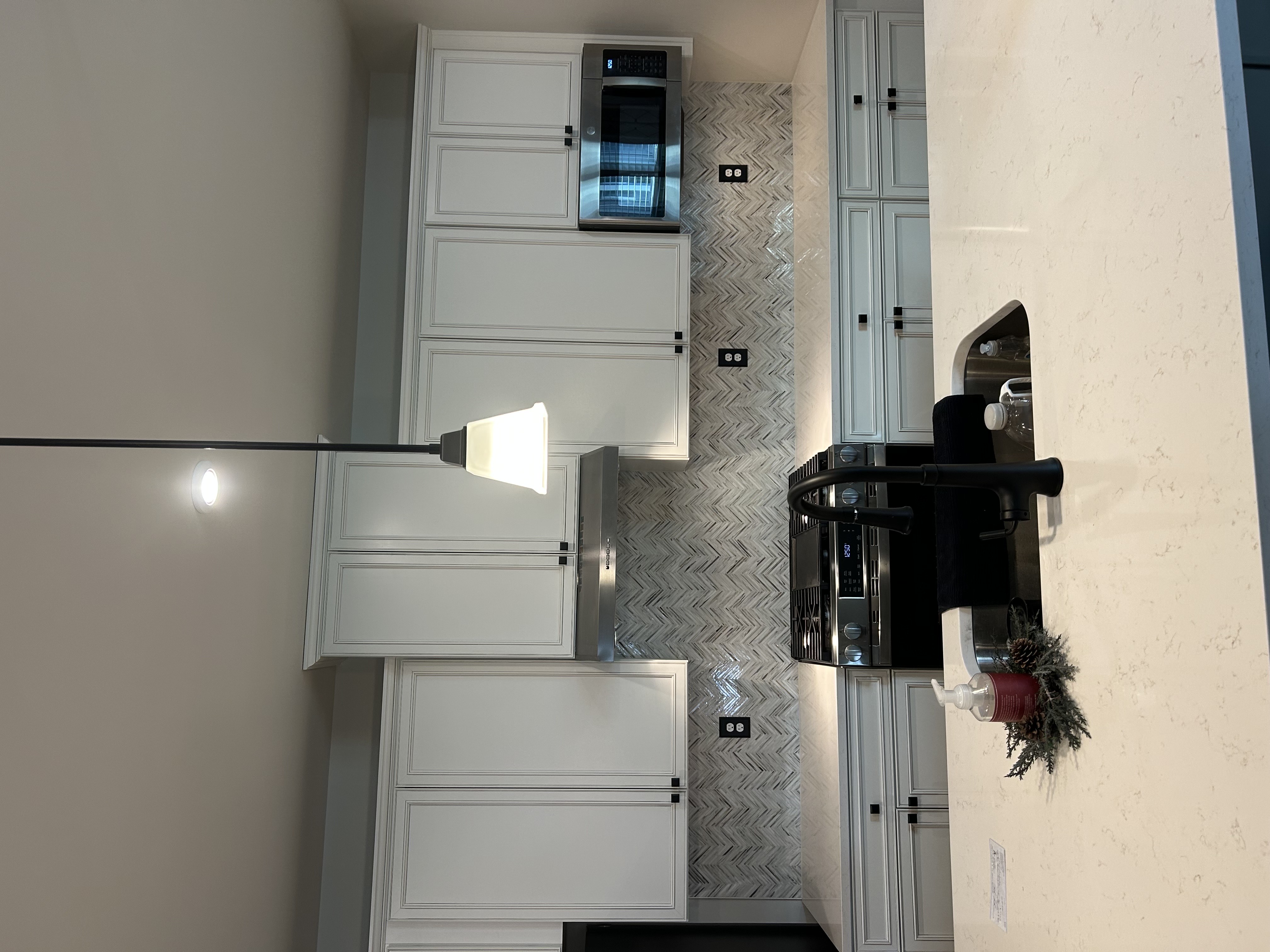 An overview of a kitchen with a white tile backsplash